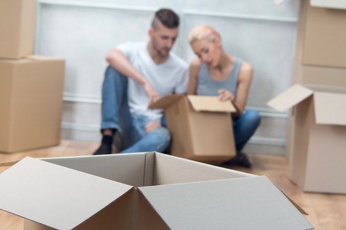 Packed boxes and furniture being loaded into a removals van