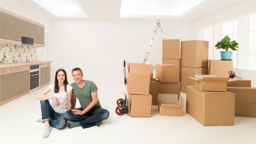Office relocation team moving desks and boxes safely